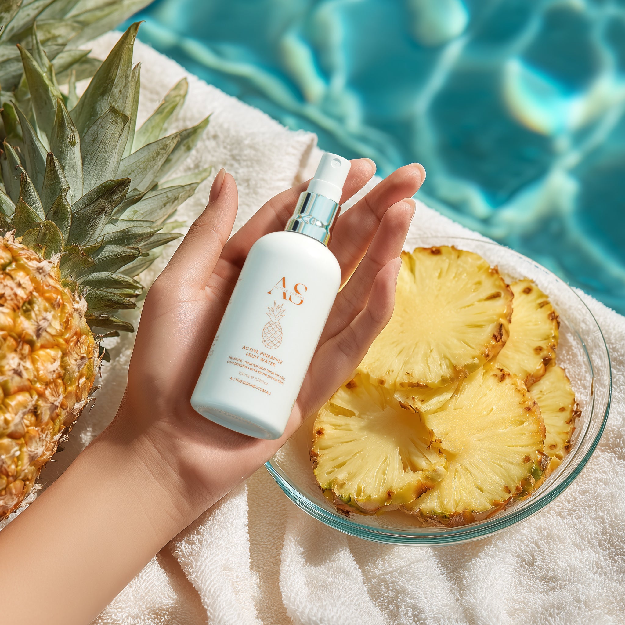 Active Pineapple Fruit Water held in hand by a sparkling blue pool with fresh pineapple slices.