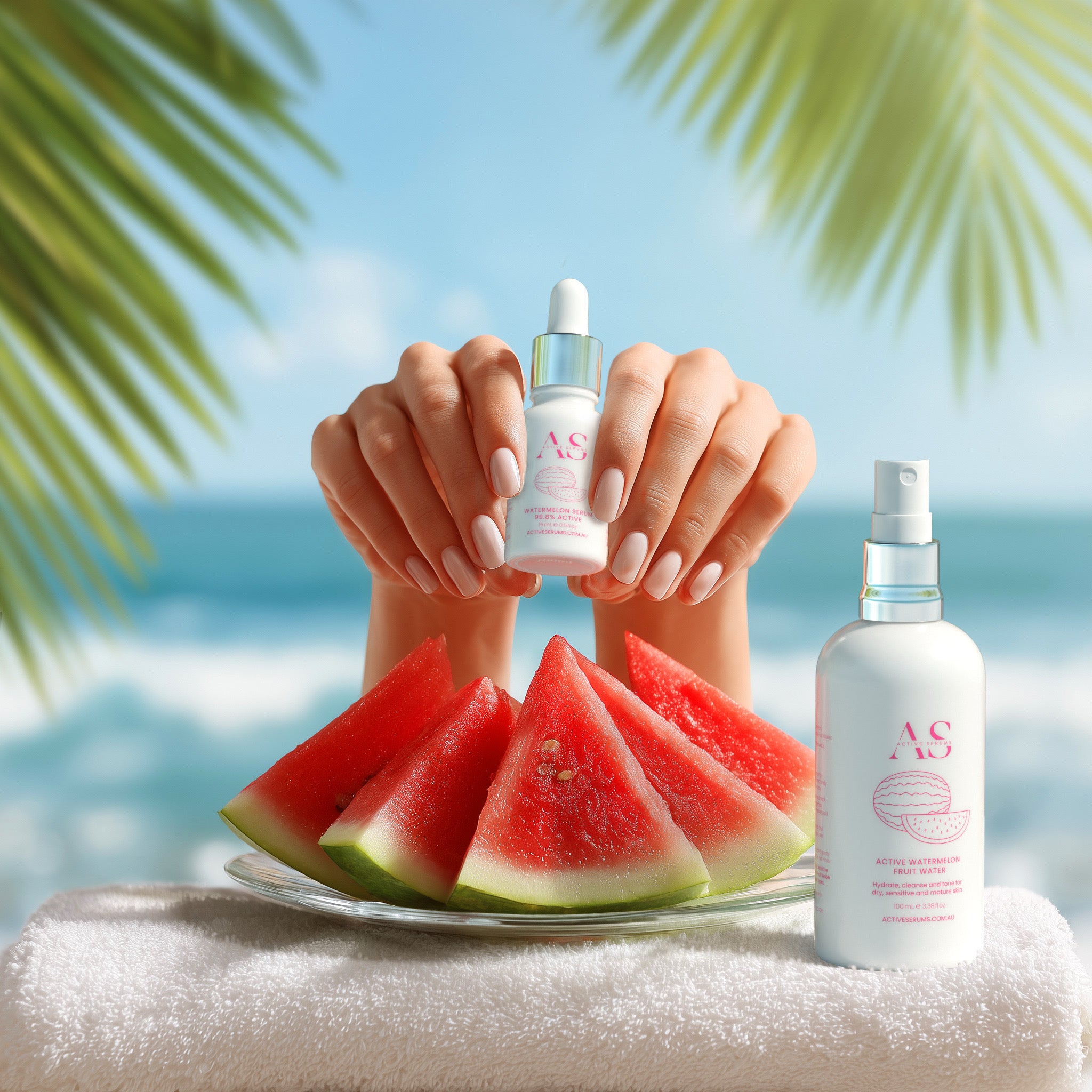 Hands holding Active Watermelon Duo serum next to fruit slices and Fruit Water mist spray on a sunny beach.