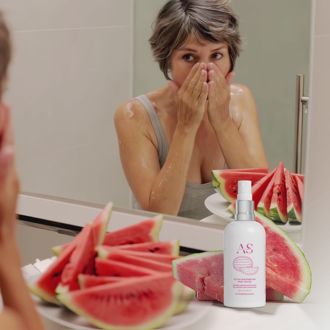Video of a woman cleansing her face with Active Watermelon Fruit Water next to fresh watermelon slices.