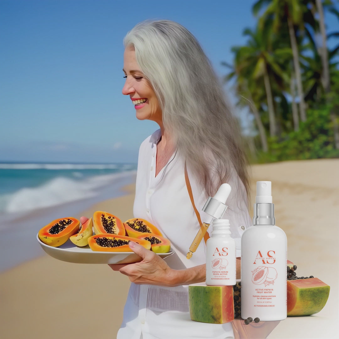 Active Papaya Duo skincare featured in a lifestyle video of a woman walking on a tropical beach with fresh papayas.