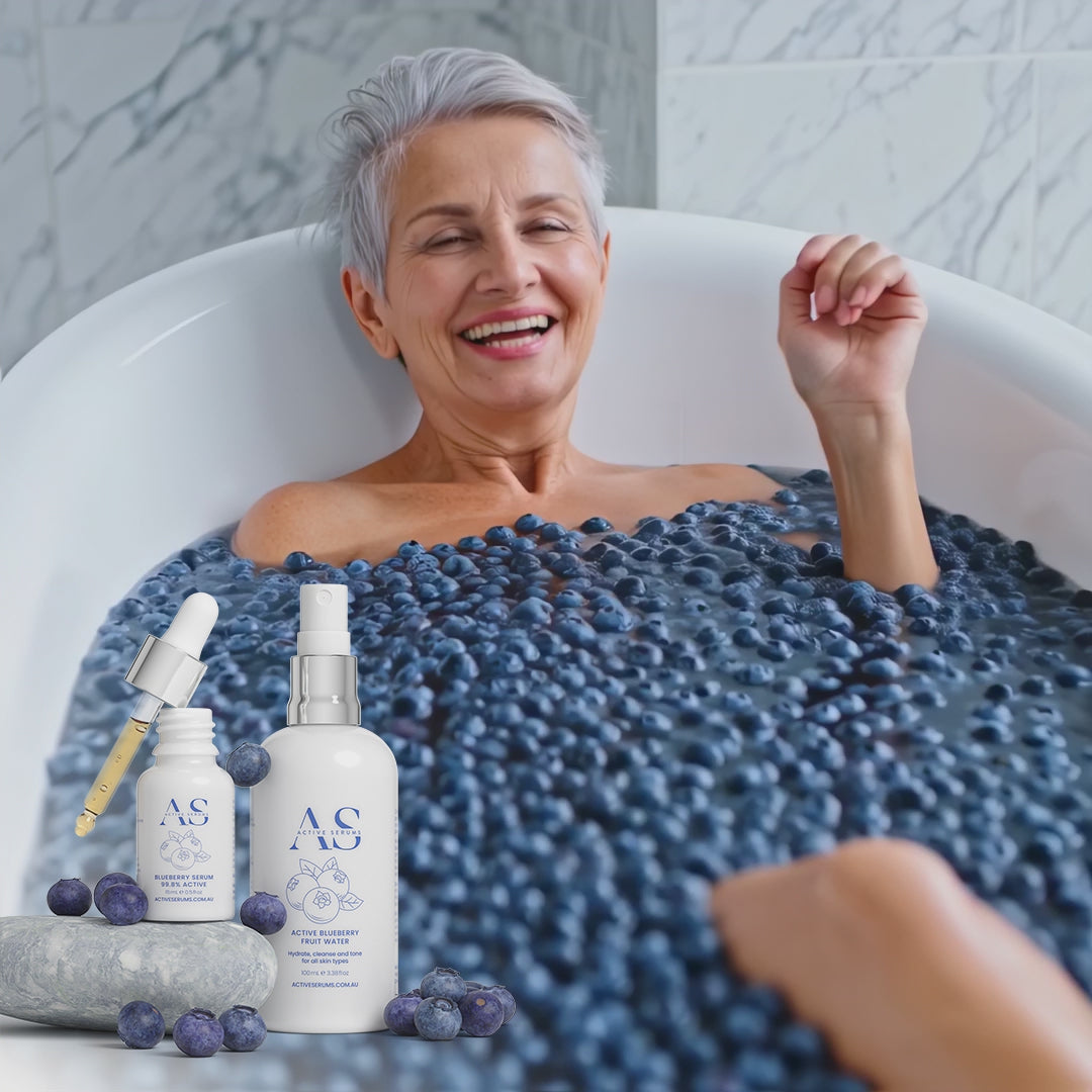 Active Blueberry Duo skincare featured in a lifestyle video of a woman laughing in a bathtub filled with fresh blueberries.